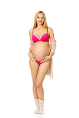 Pregnant woman in lingerie and socks