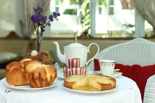 Tea time with sweet bread and muffin, apple tart and fruit