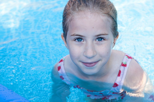 portrait of little girl in swimming pool