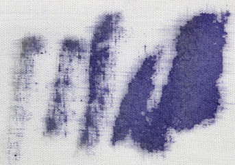 blue spots of paint on white material