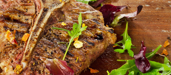Steak with Fresh Herbs on  rustic wooden table