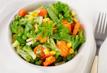 Mixed vegetables on    white plate.