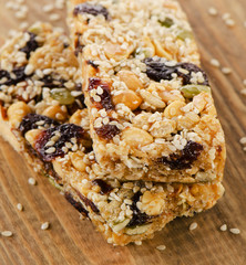 Healthy fruit and nut granola bars on  wooden table.