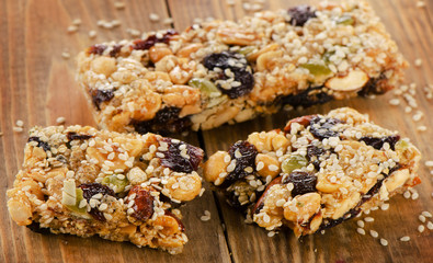 Healthy fruit and nut granola bars on a wooden table.