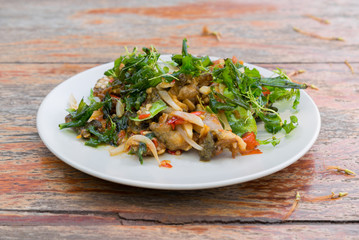 Stir-fried frog and basil on wooden, Amazing Thailand spicy food.