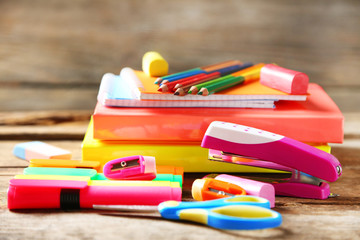 Bright school stationery on old wooden table