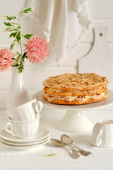 shortbread cake with nuts and meringue on a stand 