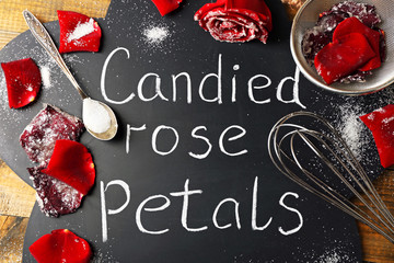 Chalkboard with inscription Candied Rose Petals, sugar and rose petals.