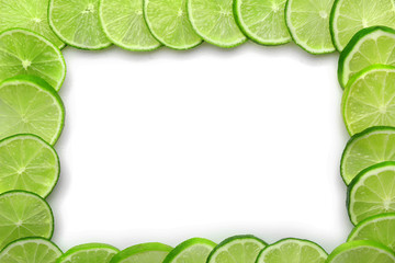 Frame of sliced fresh limes isolated on white