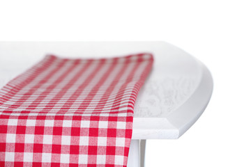 Wooden table with napkin isolated on white