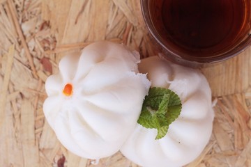 steamed pork buns, chinese dim sum and hot tea