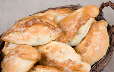Homemade patties by grandma in a wooden vintage basket on a sackcloth  