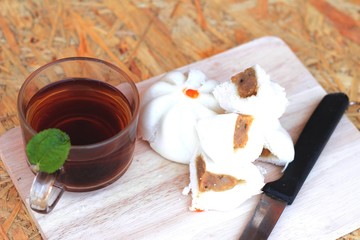 steamed pork buns, chinese dim sum and hot tea