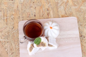 steamed pork buns, chinese dim sum and hot tea