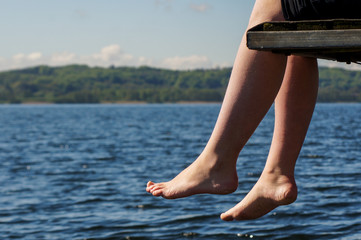 Legs hanging of a Jetty