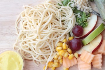 Pasta spaghetti with salad mix fruit.