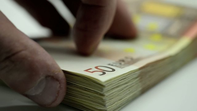 Euro money bank notes 50 euros, with hand count fortune