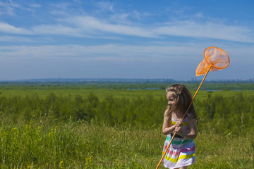 Kids summer in the meadow with orange net