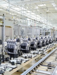 New manufactured car engines on automated production assembly line in a car factory. Manufacture of the engines for new car. New automotive engine on production line.