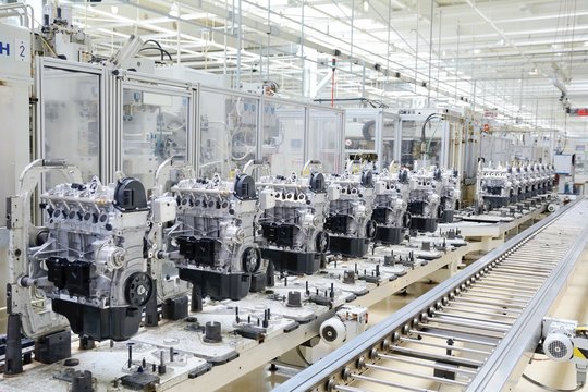 Production assembly line for manufacturing of the engines in the car factory. Car factory. Car parts. Engine factory. New engine factory. Engines on line