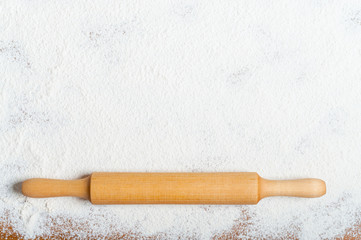 Sifted flour and rolling pin on the table. Kitchen background