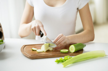 close up of woman chopping green vegetables