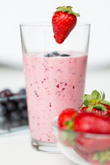 close up of milkshake decorated with strawberry
