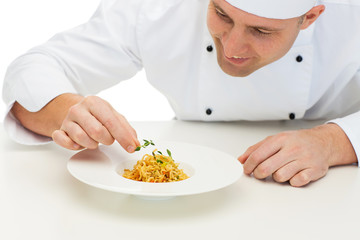 happy male chef cook decorating dish