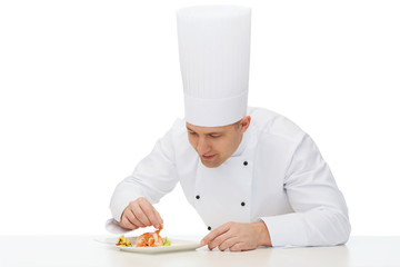happy male chef cook decorating dish