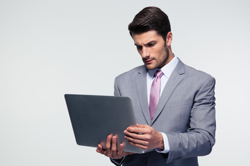 Confident businessman using laptop