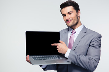 Businessman pointing finger on the laptop screen