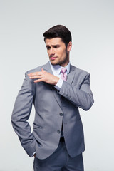 Businessman shakes off something from his shoulder