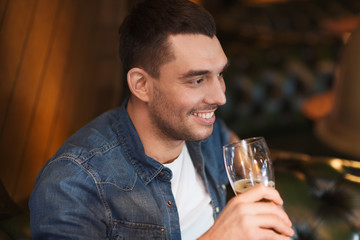 happy man drinking beer at bar or pub
