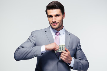 Businessman putting money in pocket
