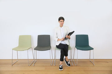 Woman sittin on chair waiting for job interview