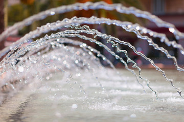 Curved water jets from the fountain.