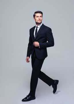 Businessman walking over gray background