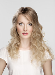 Fototapeta premium Portrait of perfect curvy young blond girl with makeup and retou