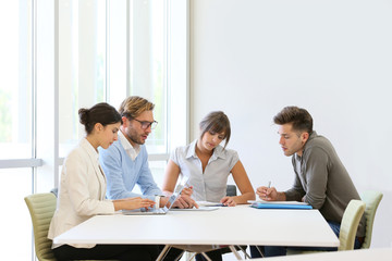 Business people meeting around table in modern space