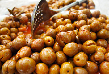 Pile of green olives with paprika at spanish market