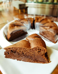 Dark chocolate cake on white plate / in bakery shop