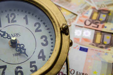 Financial concept - clock and Euro money