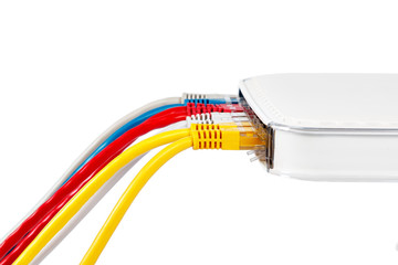 Multicolored network cables connected to router on a white background