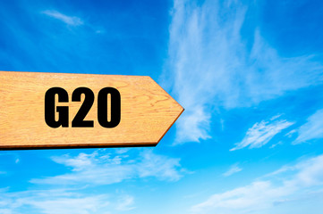 Wooden arrow sign pointing destination G20 SUMMIT