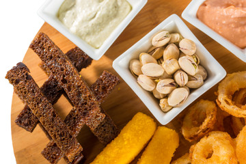 Cheese sticks, onion rings, crackers, salted peanuts and sauce
