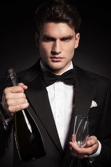 elegant young man holding two glasses
