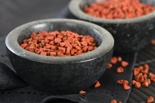 Annatto Seeds - Annatto (achiote) seeds in a black bowl.
