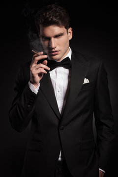 elegant young man smoking a cigarette
