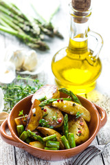     Delicious baked young potatoes on a wooden background 