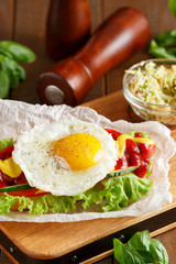 Hotdog with egg on wooden cutting board